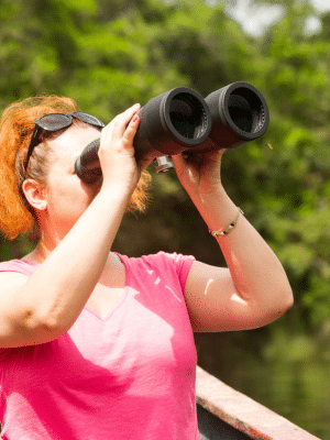 VA holding binoculars searching for clients for her VA business